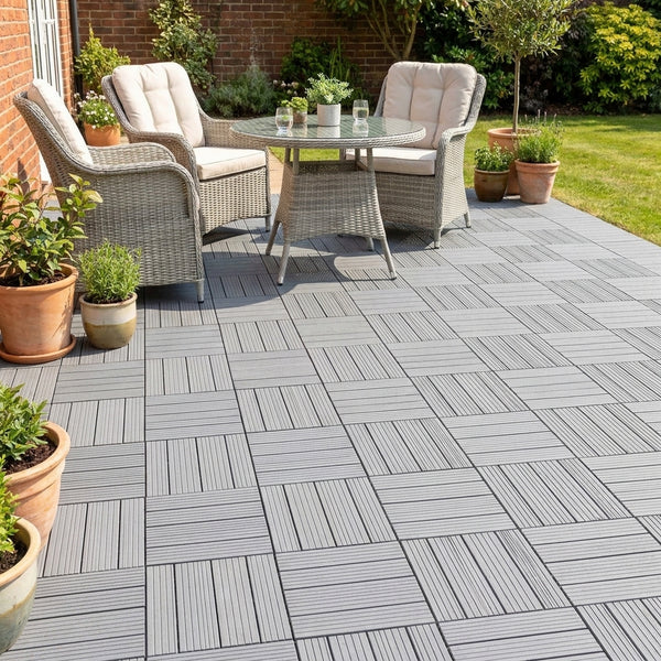 Light grey composite decking tiles on UK patio with garden furniture