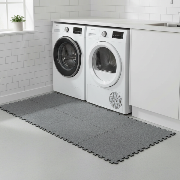 Grey protective floor mat under washing machine utility room