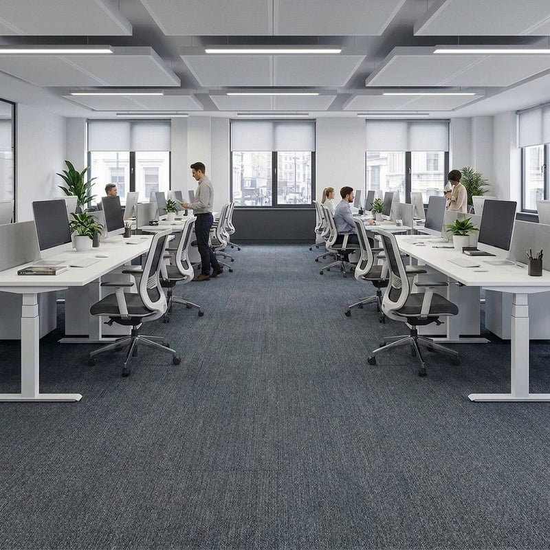 Carpet tiles covering floor in UK open plan office with standing desks