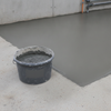 Floor Repair PU Mortar container beside freshly repaired concrete floor in agricultural setting