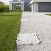 Natural white X-Grid permeable ground reinforcement panel installed as white gravel garden path at contemporary UK home