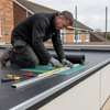 Professional roofer fitting EPDM wall abutment trim flat roof
