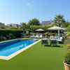 Non-slip artificial grass around luxury UK swimming pool with loungers