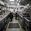 Wet area drainage mat in British pub kitchen - chef standing on anti-fatigue floor mat UK