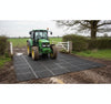 Rubber grass mat at farm gateway providing tractor-rated ground protection