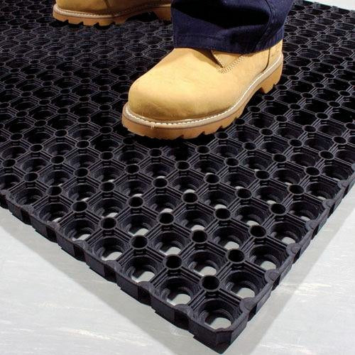 Boots standing on heavy-duty roof matting tile