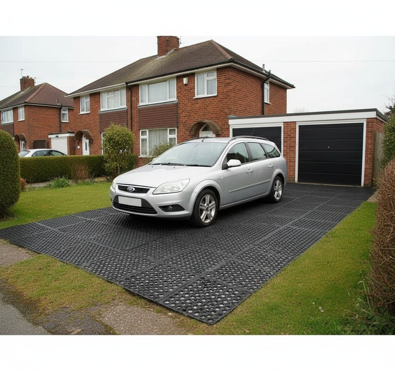 Heavy duty rubber mats supporting vehicle weight on grass