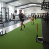 Sports performance training facility with sprint track flooring