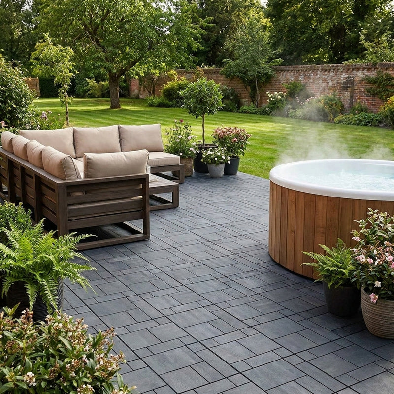 Grey recycled composite decking tiles around UK garden hot tub