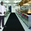 British restaurant kitchen with chef on drainage mat