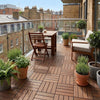 Fir wood deck tiles on UK apartment balcony with plants and bistro chairs