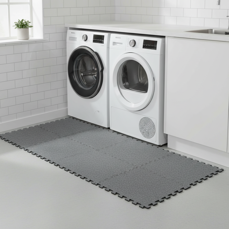 Grey protective floor mat under washing machine utility room