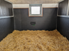 EVA stable wall mats installed in UK horse stable showing black checkerplate foam panels