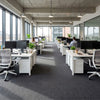 Heavy duty carpet tiles in UK commercial office with rows of workstations