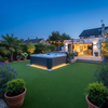 Artificial grass installed around hot tub in modern UK garden
