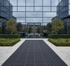 Rubber grass mat at commercial building entrance providing anti-slip access