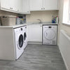 Grey oak vinyl lino flooring in UK utility room