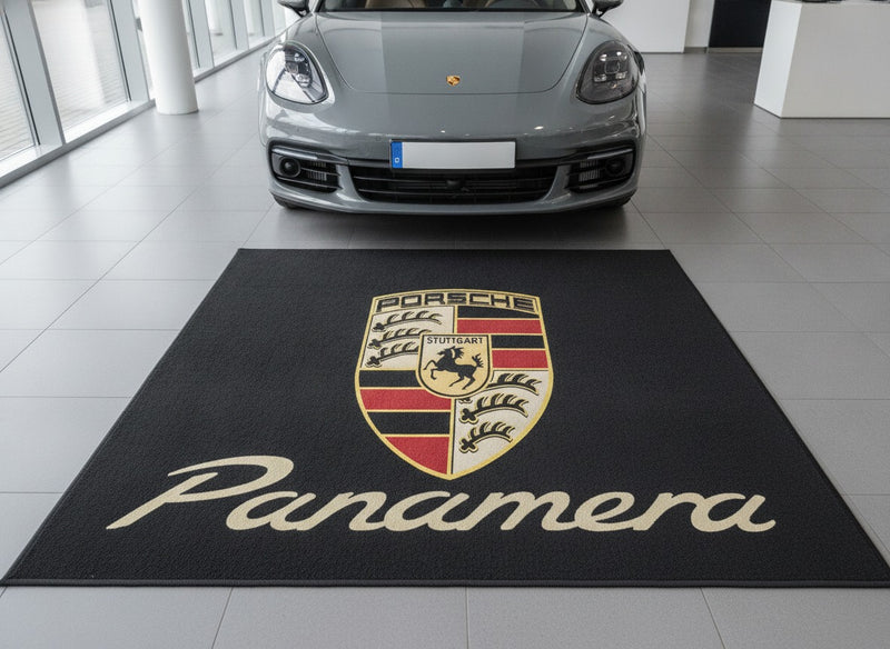 Porsche Panamera showroom parking rug in front of a Chalk grey Panamera on pale porcelain tiles