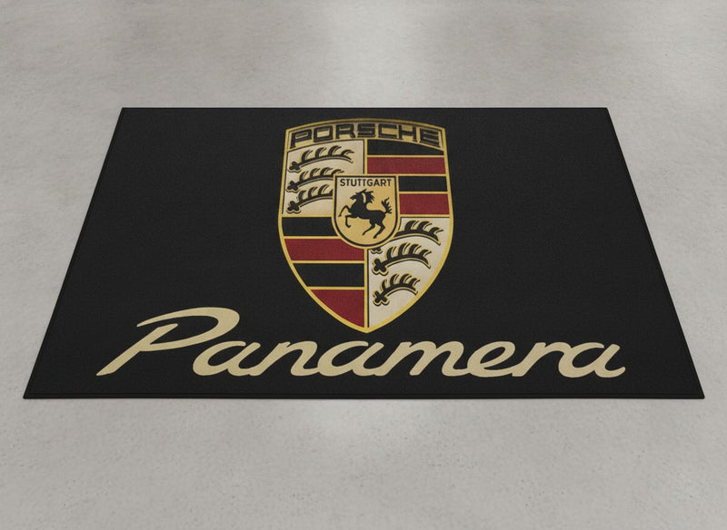 Porsche Panamera garage mat flat lay showing the full crest and gold Panamera script on black
