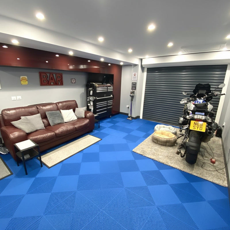 Racing blue PVC garage floor tiles in automotive workshop