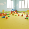Yellow EVA foam interlocking floor tiles in children play area with toys