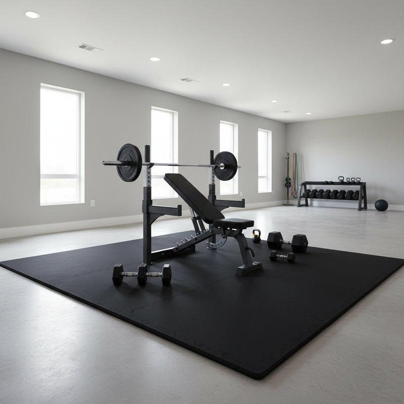 Black EVA foam exercise mats under gym equipment in professional home gym setup