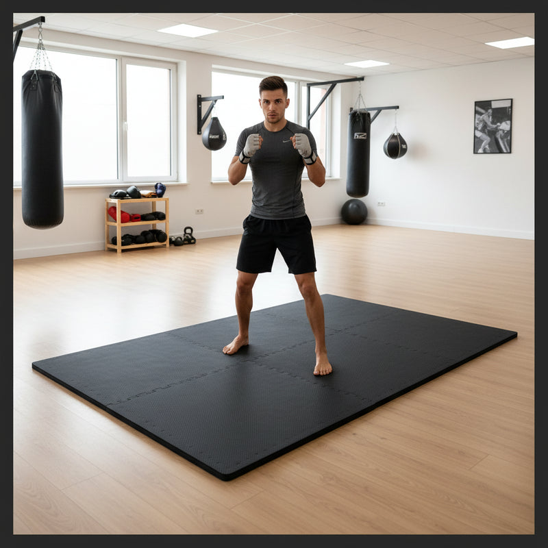 Black EVA foam exercise mats in martial arts MMA training area - person in fighting stance