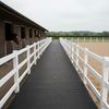 StableFlex rubber walkway tiles installed outdoors at British equestrian centre, 1m x 1m 20mm thick pathway flooring connecting stables to arena