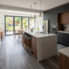 Self-adhesive wood effect vinyl planks installed in UK open-plan kitchen diner