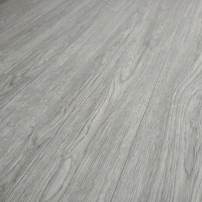 Washed grey self-adhesive vinyl plank flooring texture close-up