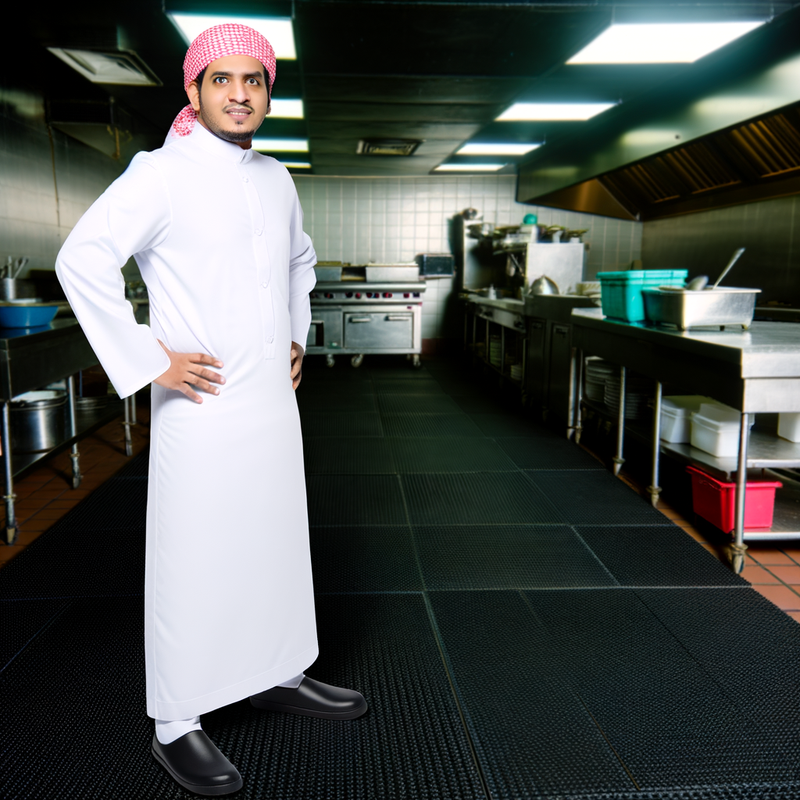 Chef working on drainage mat in commercial kitchen